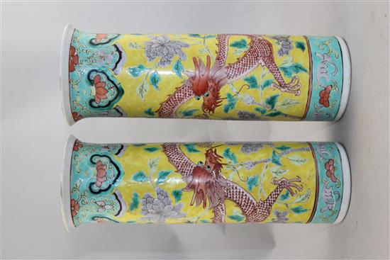 A pair of Chinese famille rose yellow ground sleeve vases, Kangxi mark, late 19th century, 26cm